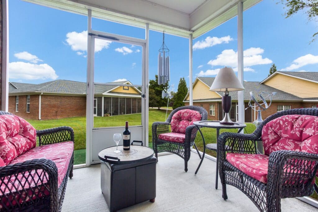 Outdoor sitting area with comfortable seating and greenery