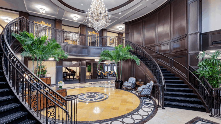 Luxurious lobby with a grand staircase and seating area