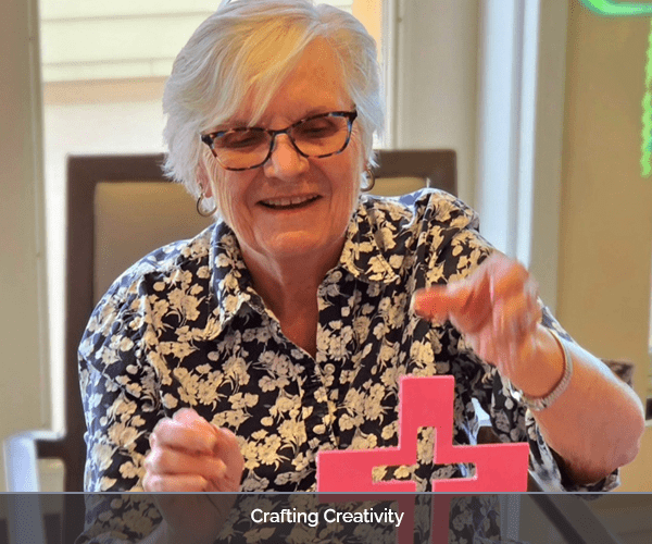 Resident engaged in a creative activity with materials