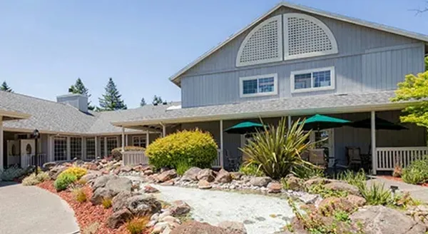 Exterior view of a senior living facility with landscaping