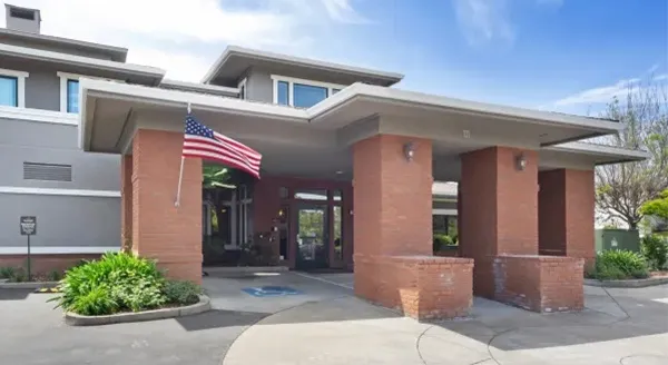 Front entrance of a senior living facility with landscaping