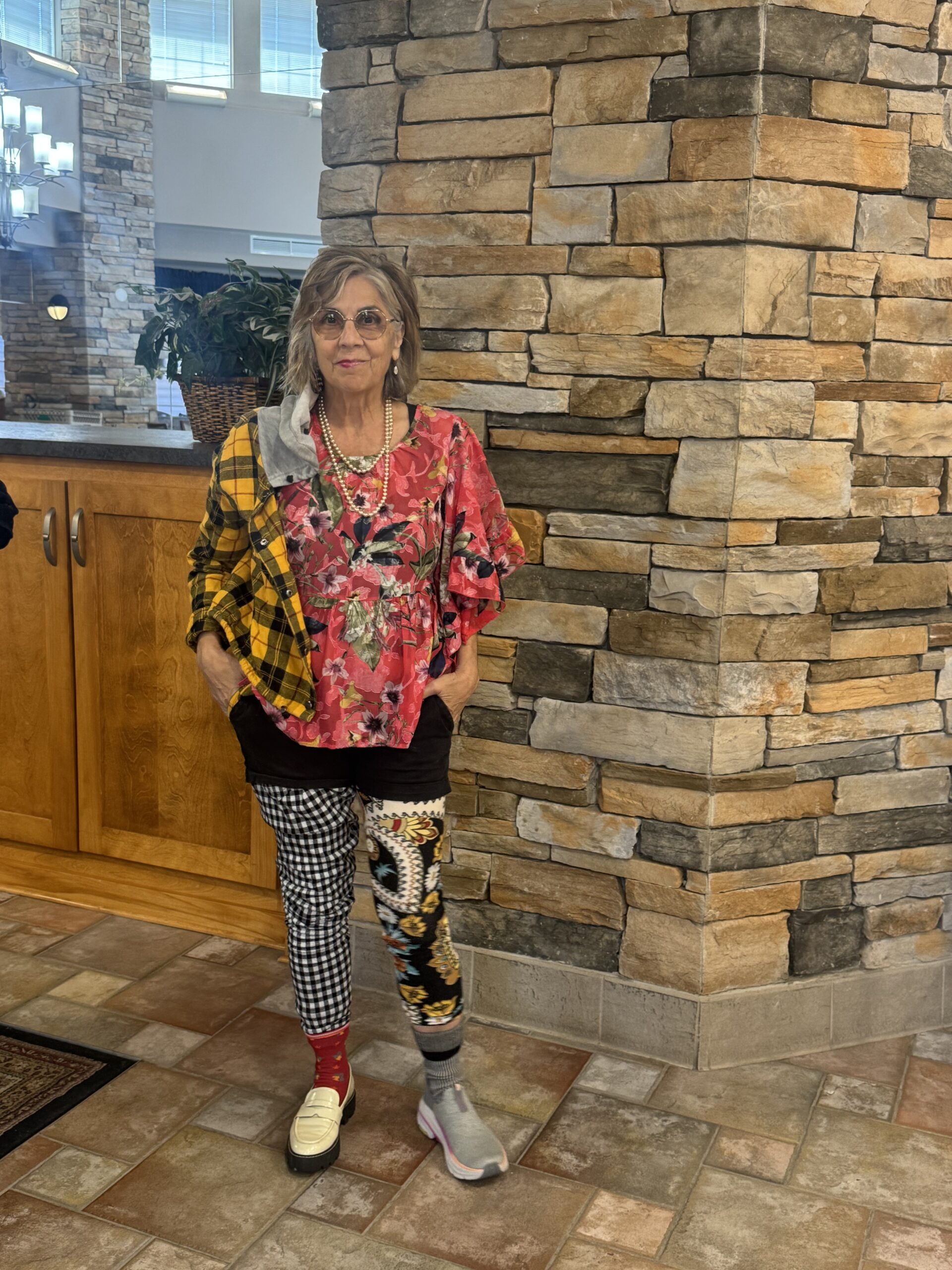 Resident posing in a brightly decorated interior