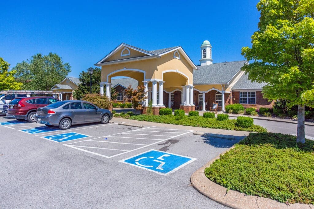 Exterior view of a senior living facility with parking