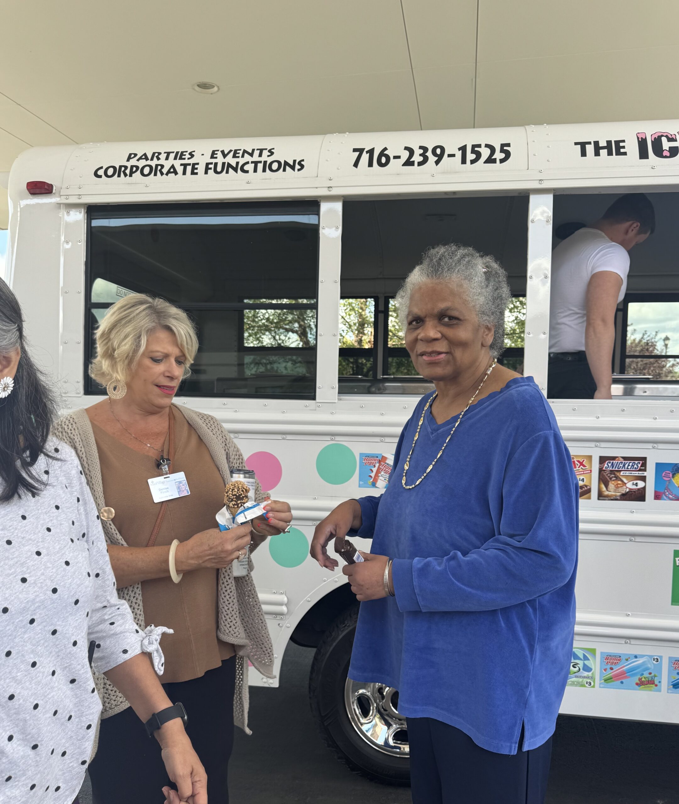 Residents enjoying ice cream near a service vehicle