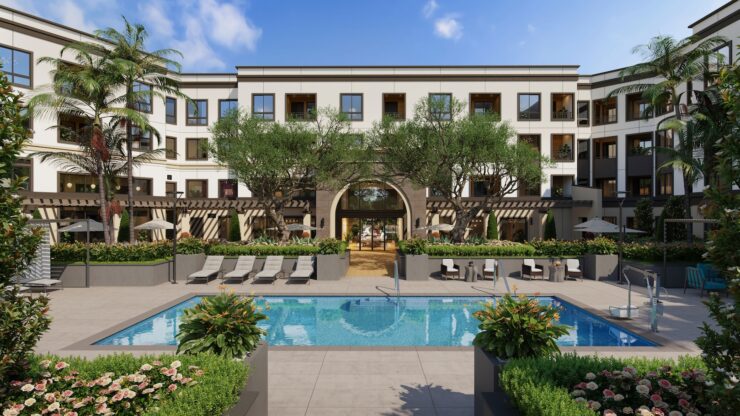 Outdoor pool area with seating and greenery