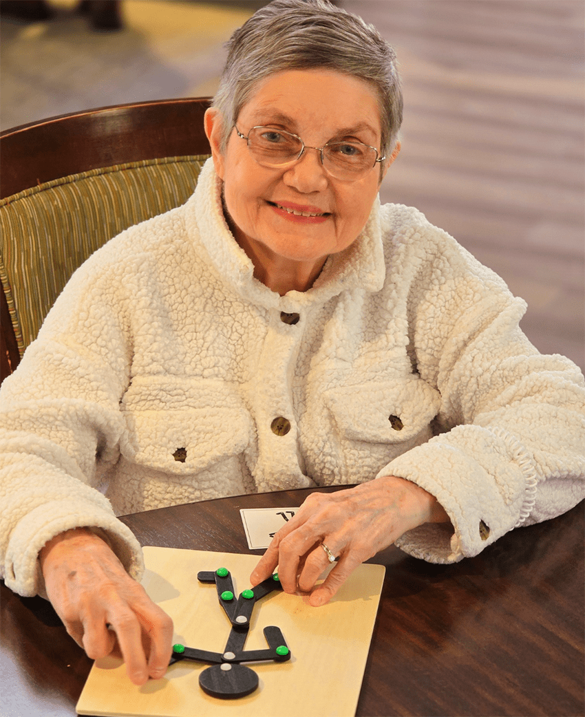 Resident playing a game at a table
