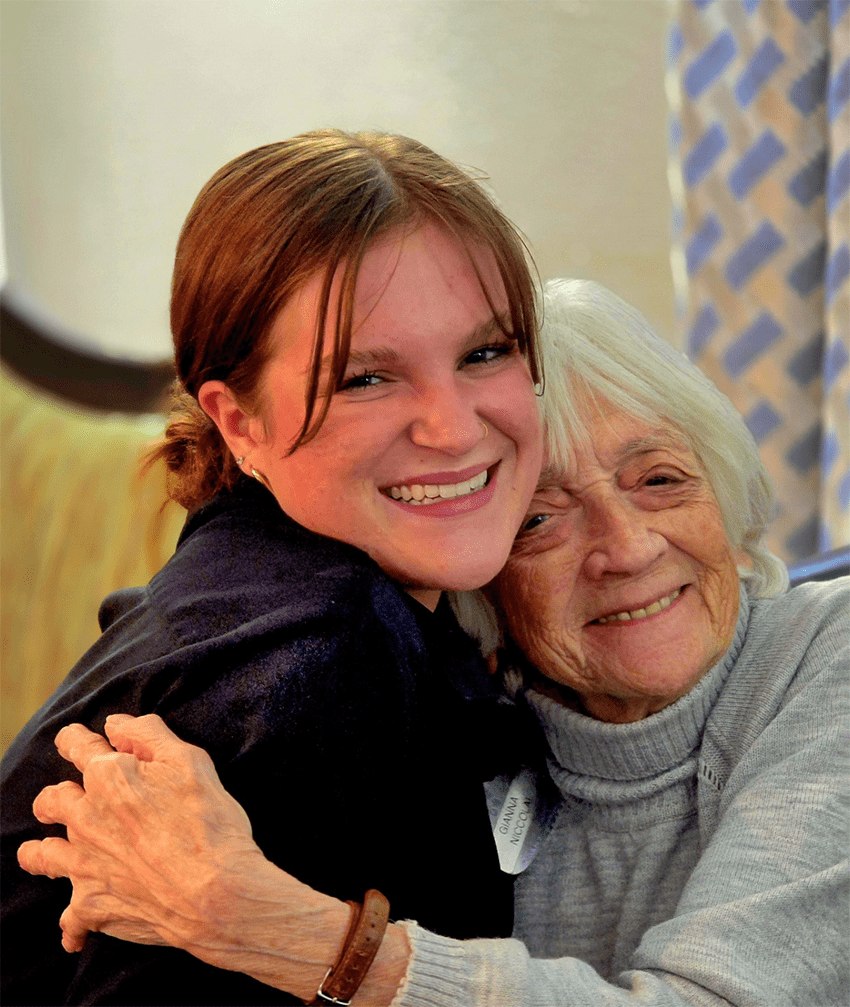 Staff hugging a resident in a warm environment