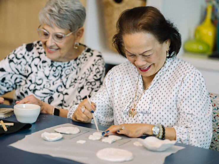 Residents engaging in a clay activity in a common room