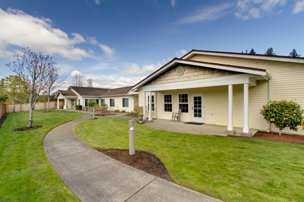 Exterior view of a senior living facility with walking paths