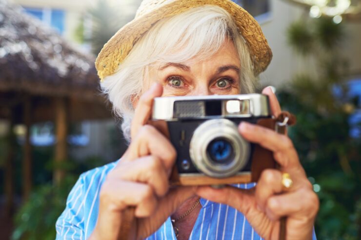 Senior resident taking a photo outdoors