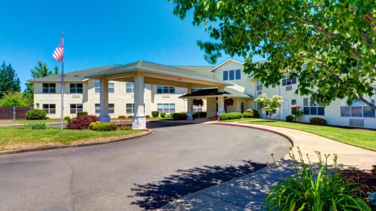 Exterior view of a senior living facility with a covered entrance