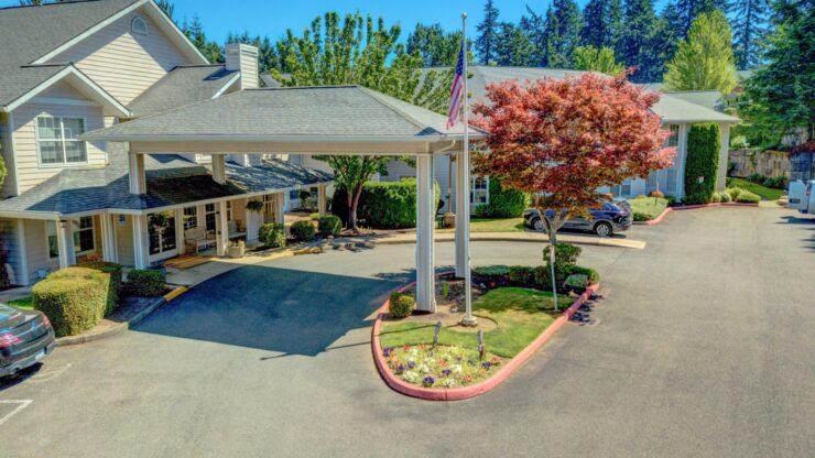 Exterior view of a senior living facility with parking and landscaping