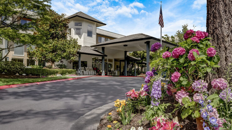 Exterior view of assisted living facility with flowers