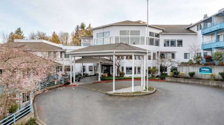 Exterior view of a senior living facility with landscaping