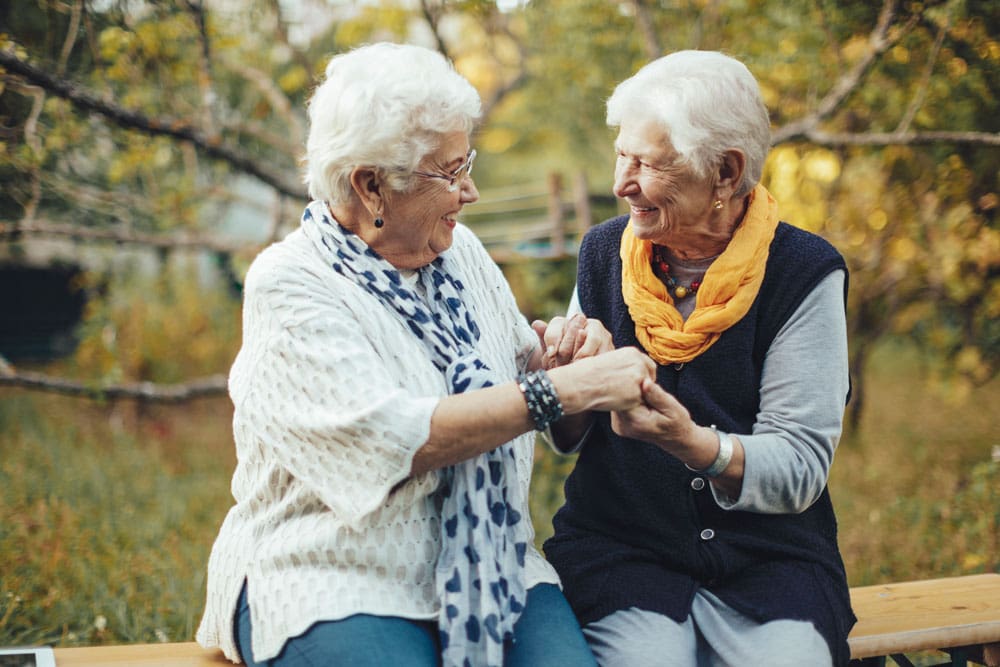 Two senior women enjoying a moment outdoors