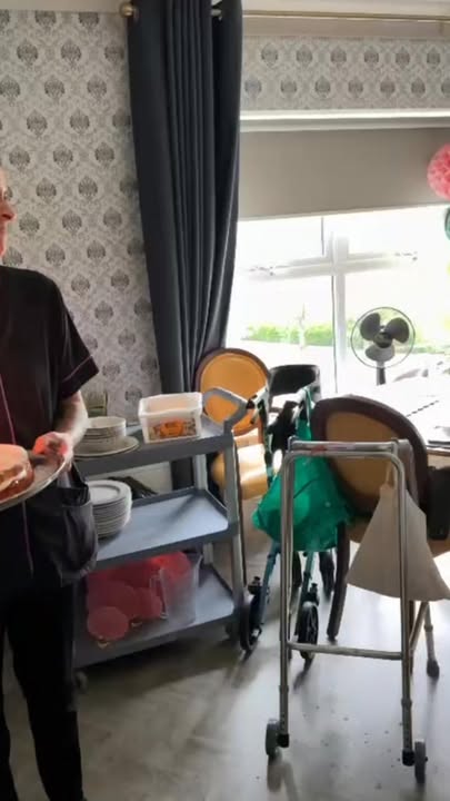 Staff member serving food in a dining area