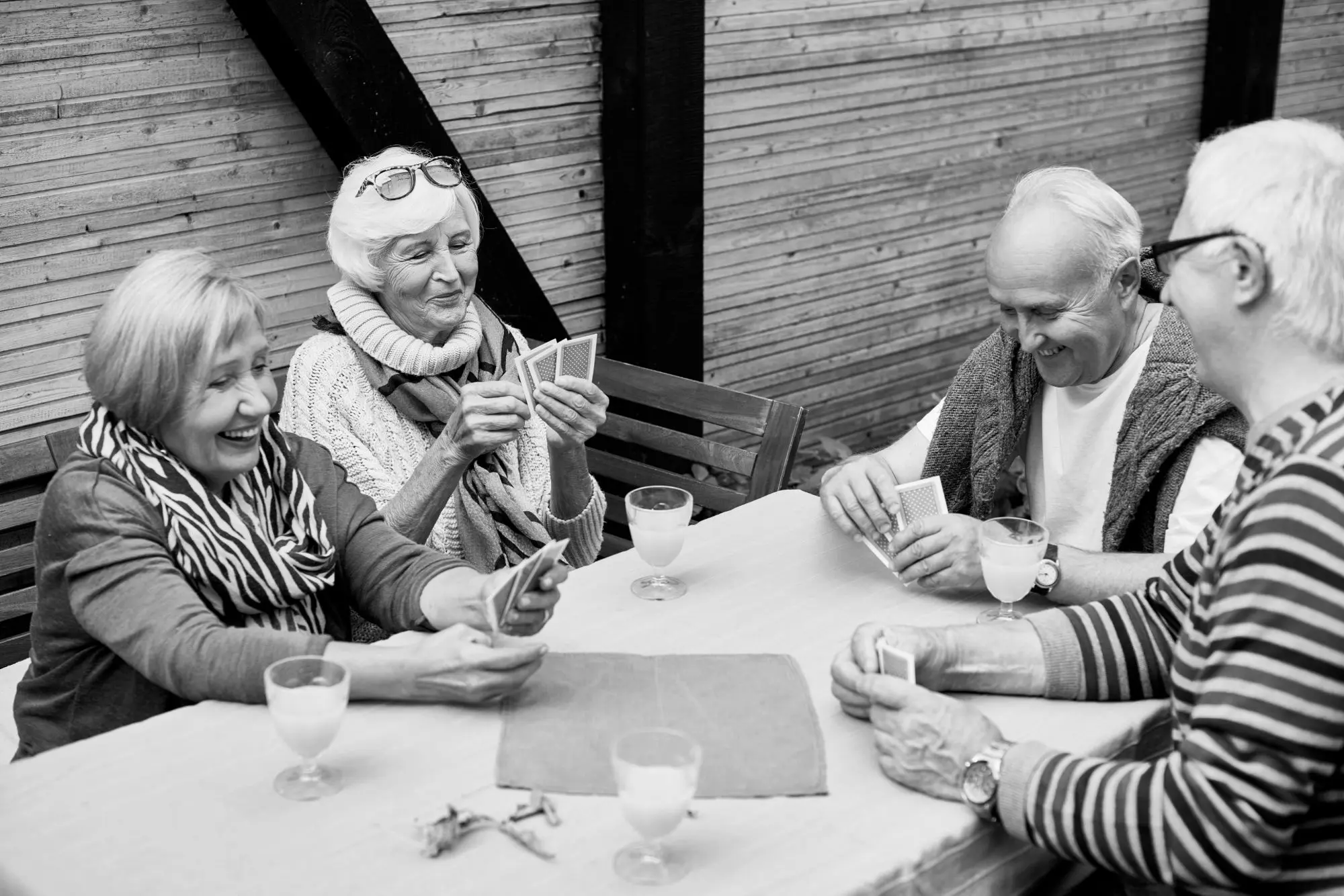 Residents playing cards together outdoors