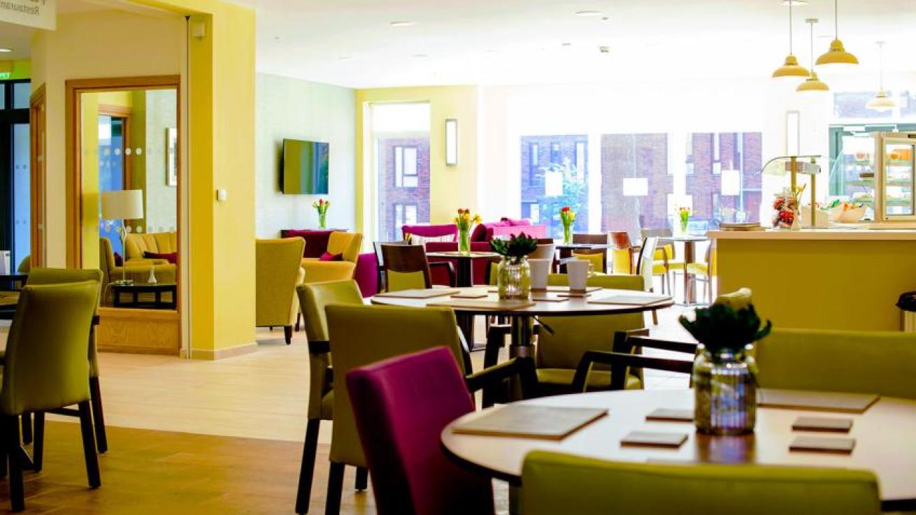 Bright dining area with colorful chairs and tables