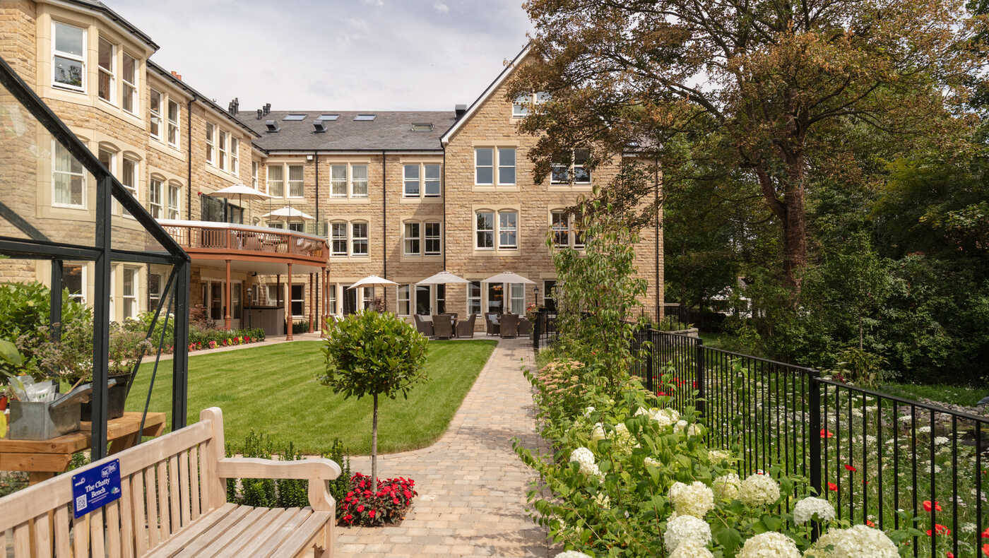 Outdoor view of Mill View assisted living facility with garden