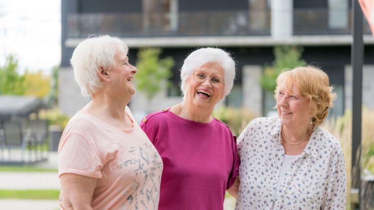 Three smiling women enjoying time together outdoors