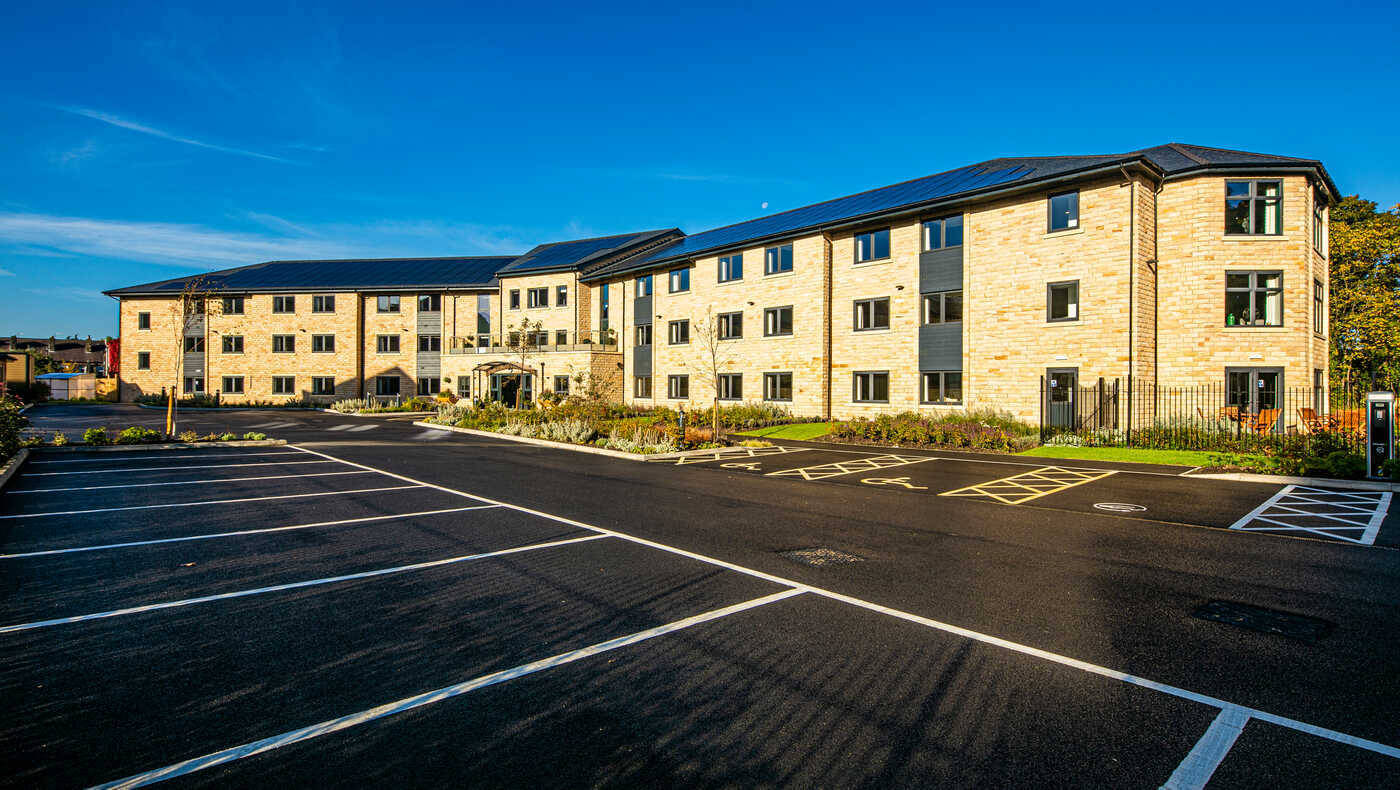 Exterior view of a senior living facility with landscaping