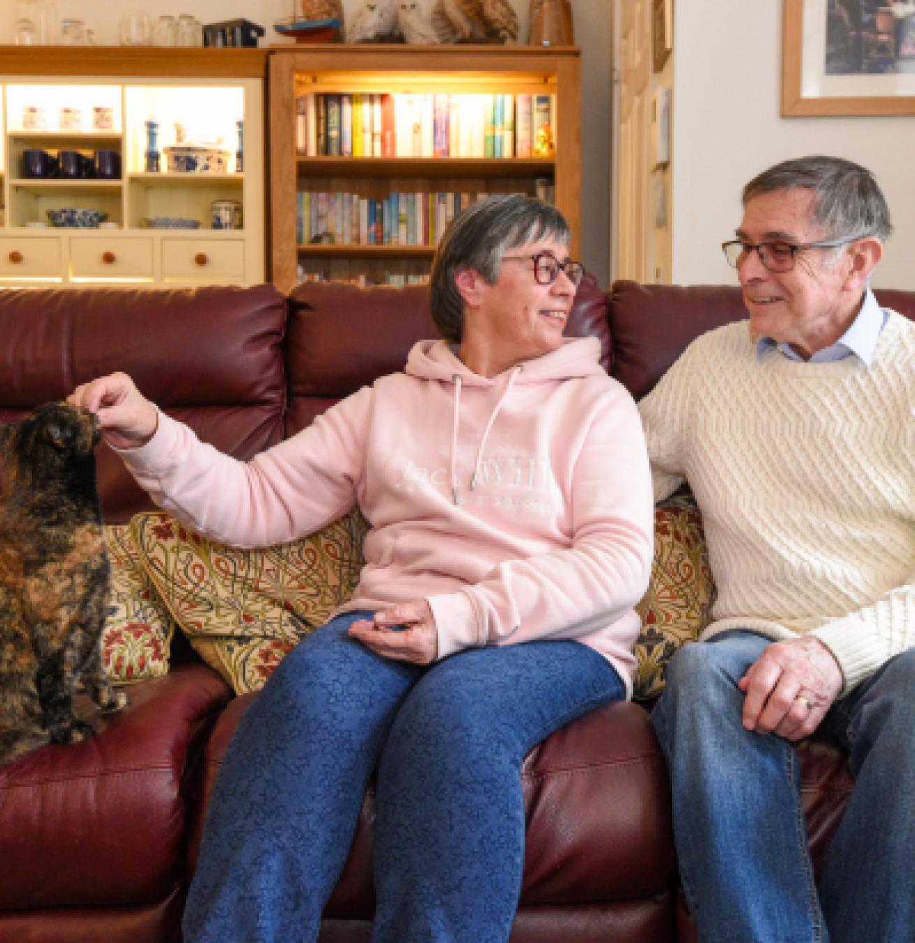 Residents enjoying time together with a cat in a cozy living area