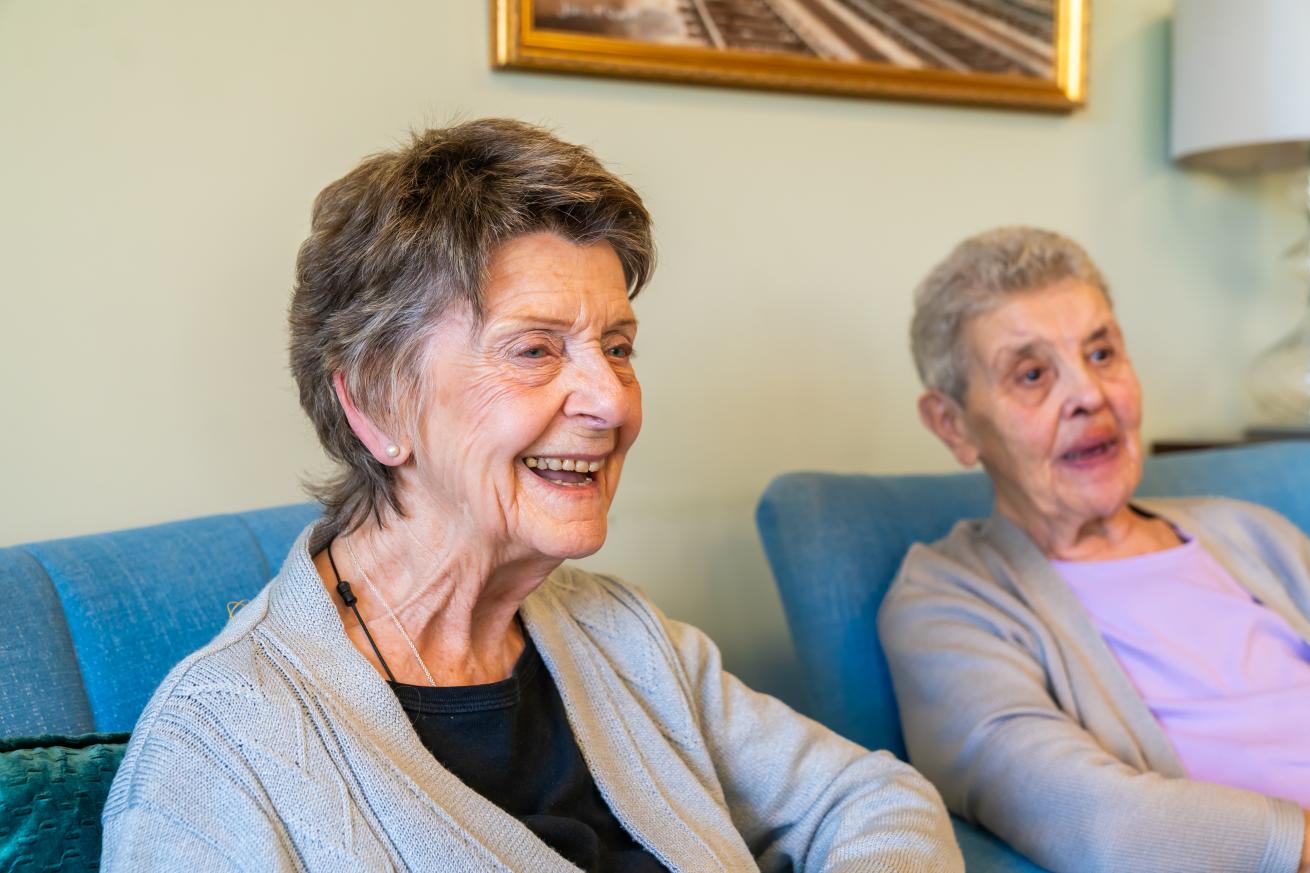 Two smiling residents enjoying each other's company