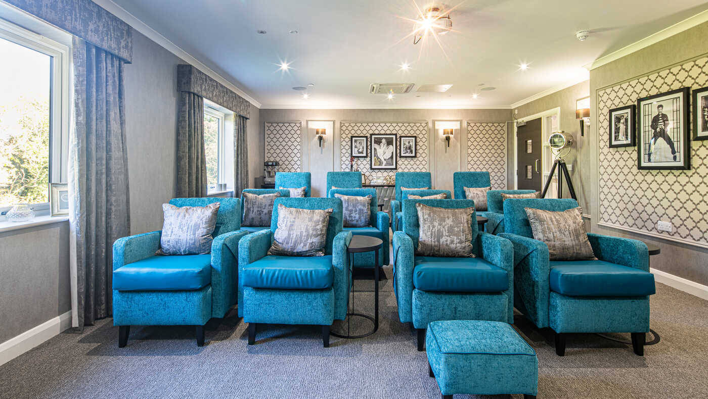 Bright interior of a common area with teal chairs