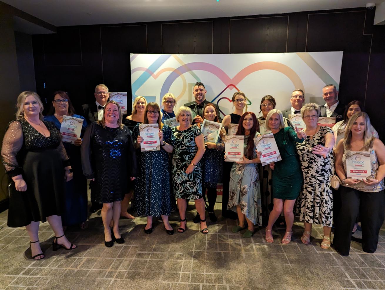 Staff and residents celebrating with awards