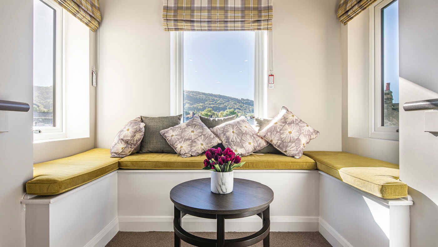 Cozy seating area with cushions and flowers