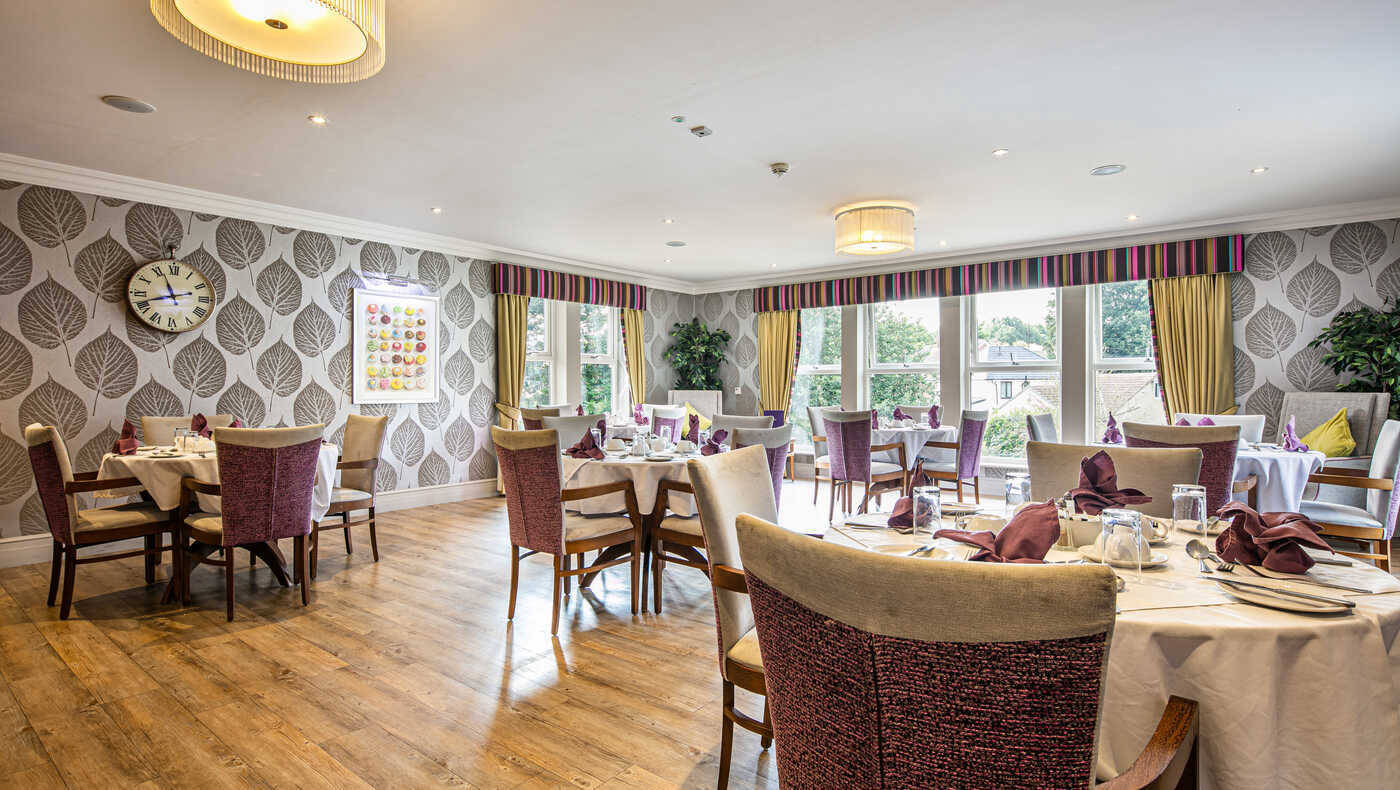 Bright dining room with set tables and large windows