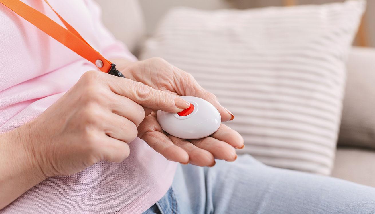 A resident pressing a medical alert button