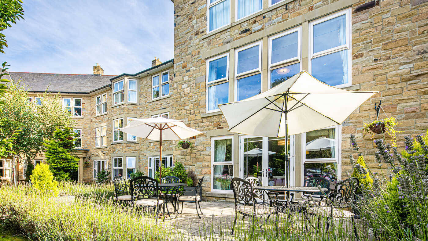 Outdoor seating area with umbrellas and garden