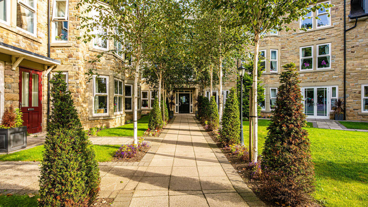 Pathway through landscaped garden with trees