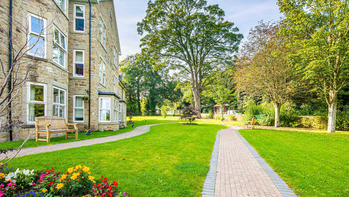 Well-maintained gardens and pathways outside the facility