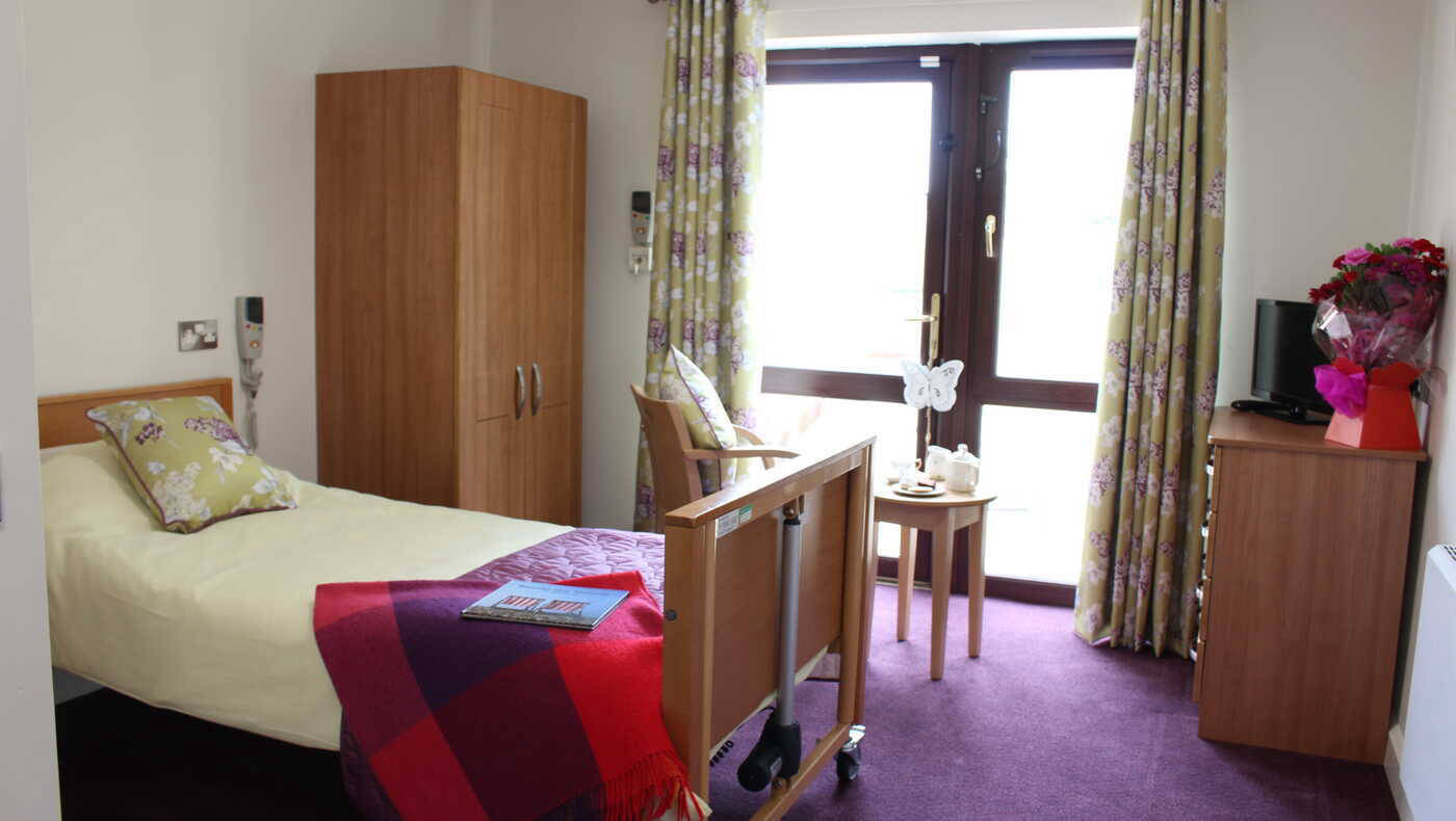Cozy private resident room with a bed and flowers