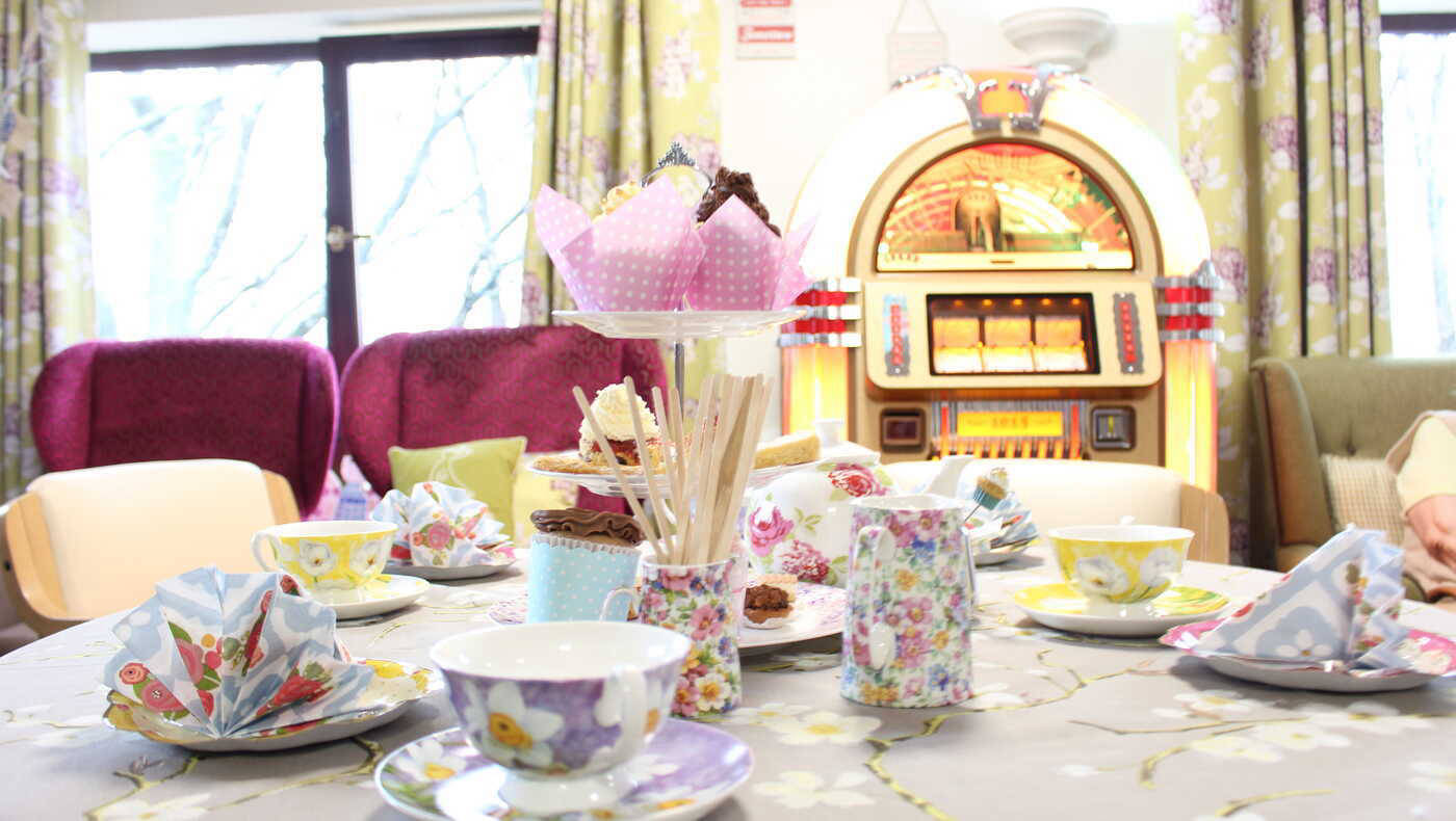 A beautifully set table with tea and snacks in a common area