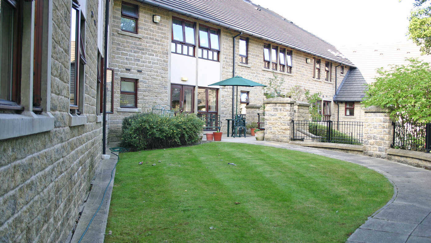 Well-maintained outdoor space with grass and patio