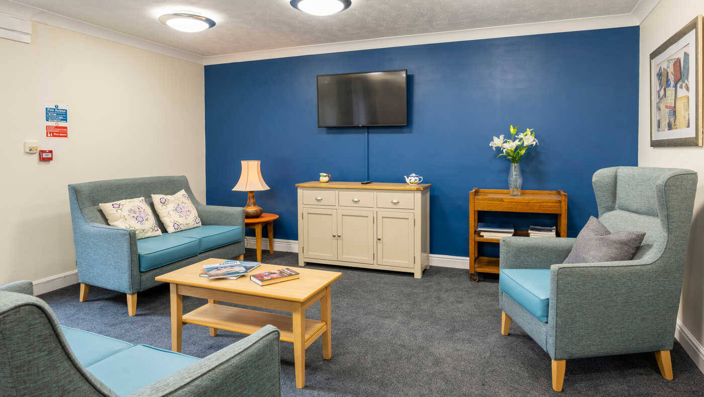 Comfortable living room area with blue accent wall