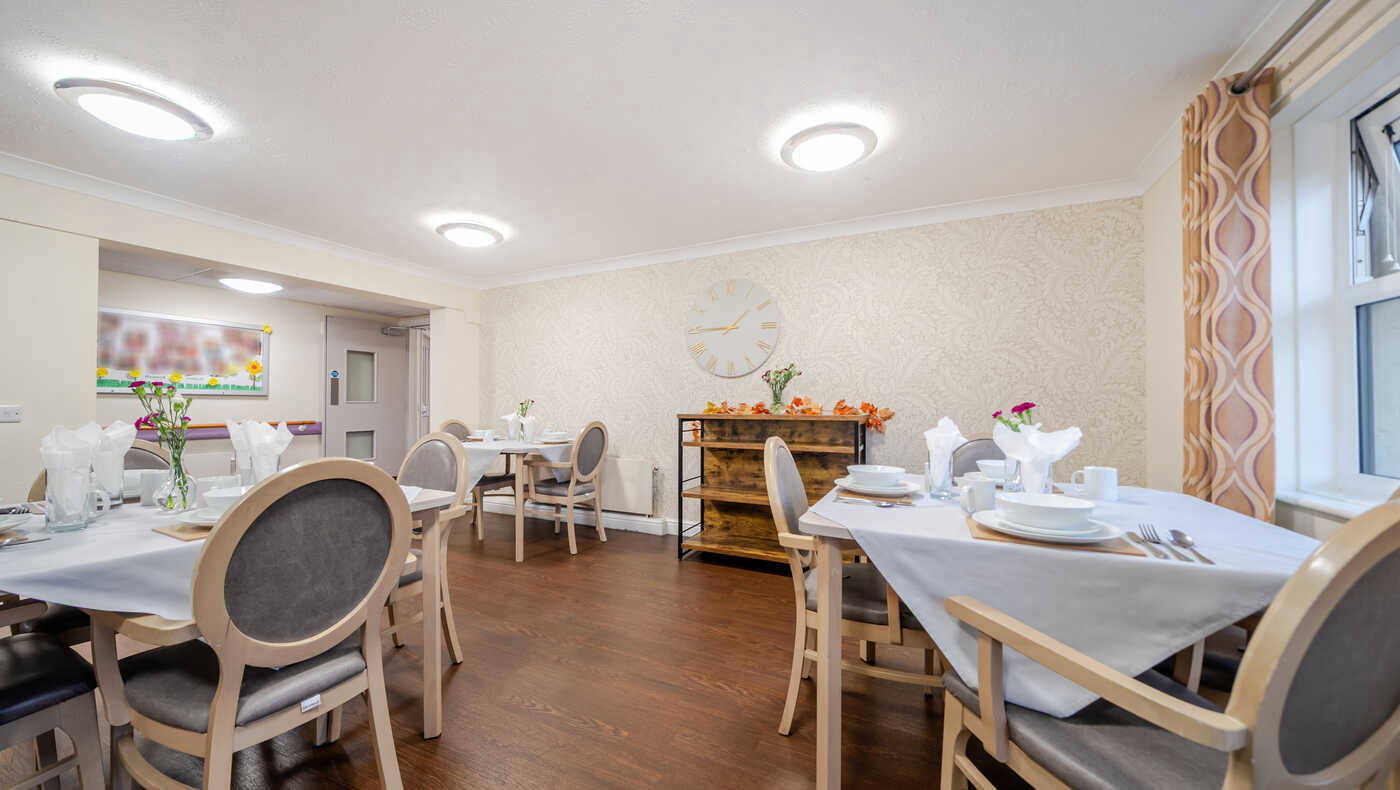 Bright dining room with tables set for meals