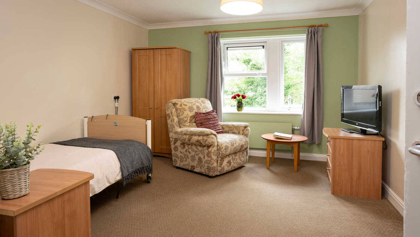 Comfortable resident room with furniture and window views