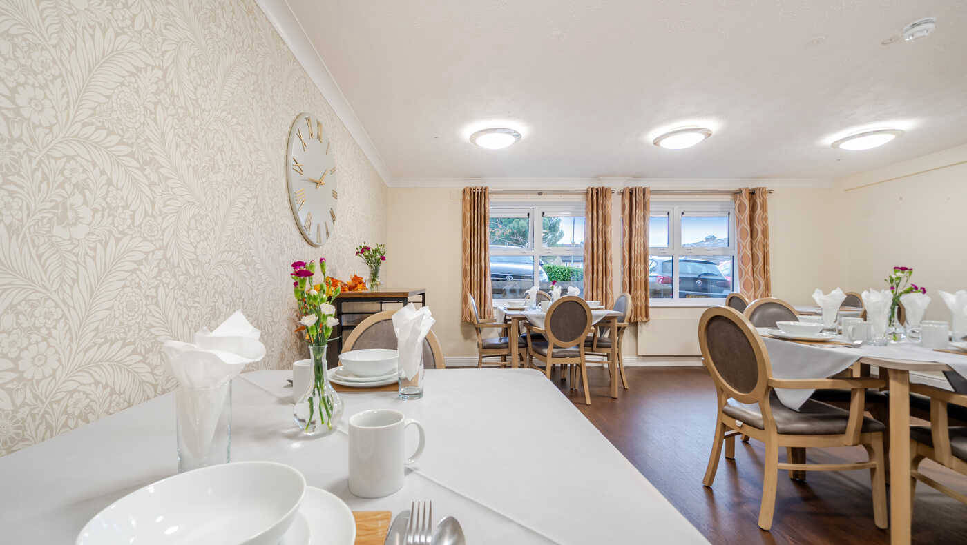 Dining room setup with tables and flowers