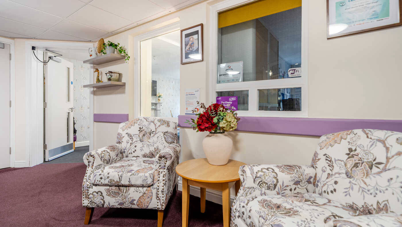Cozy seating area with floral chairs and decorations