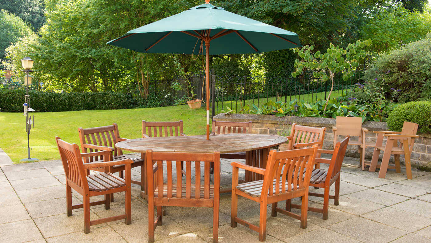 Outdoor seating area with wooden tables and chairs