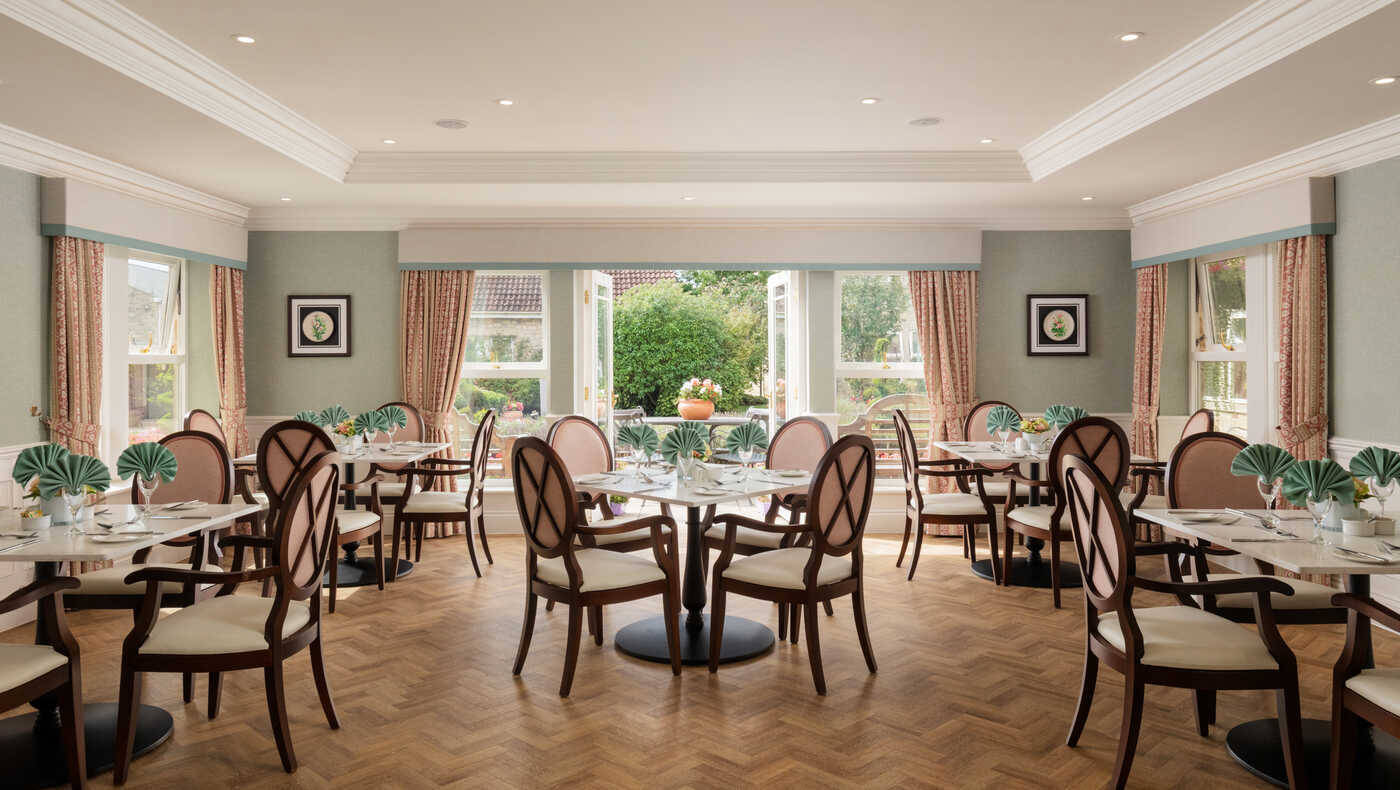 Bright dining room with tables set for meals