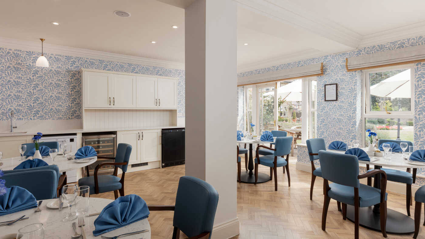 Bright dining room with tables set for meals