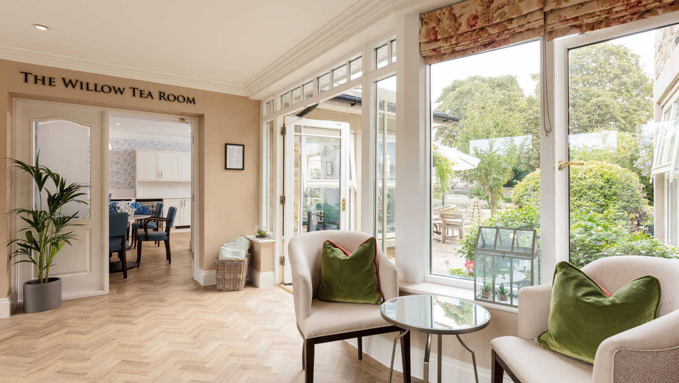 Bright tea room with seating and garden view