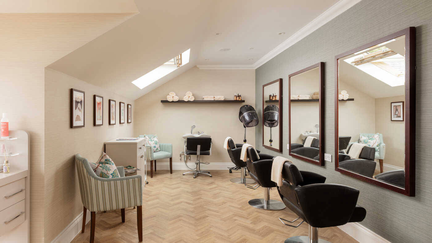 Interior of a hair salon with styling chairs and mirrors