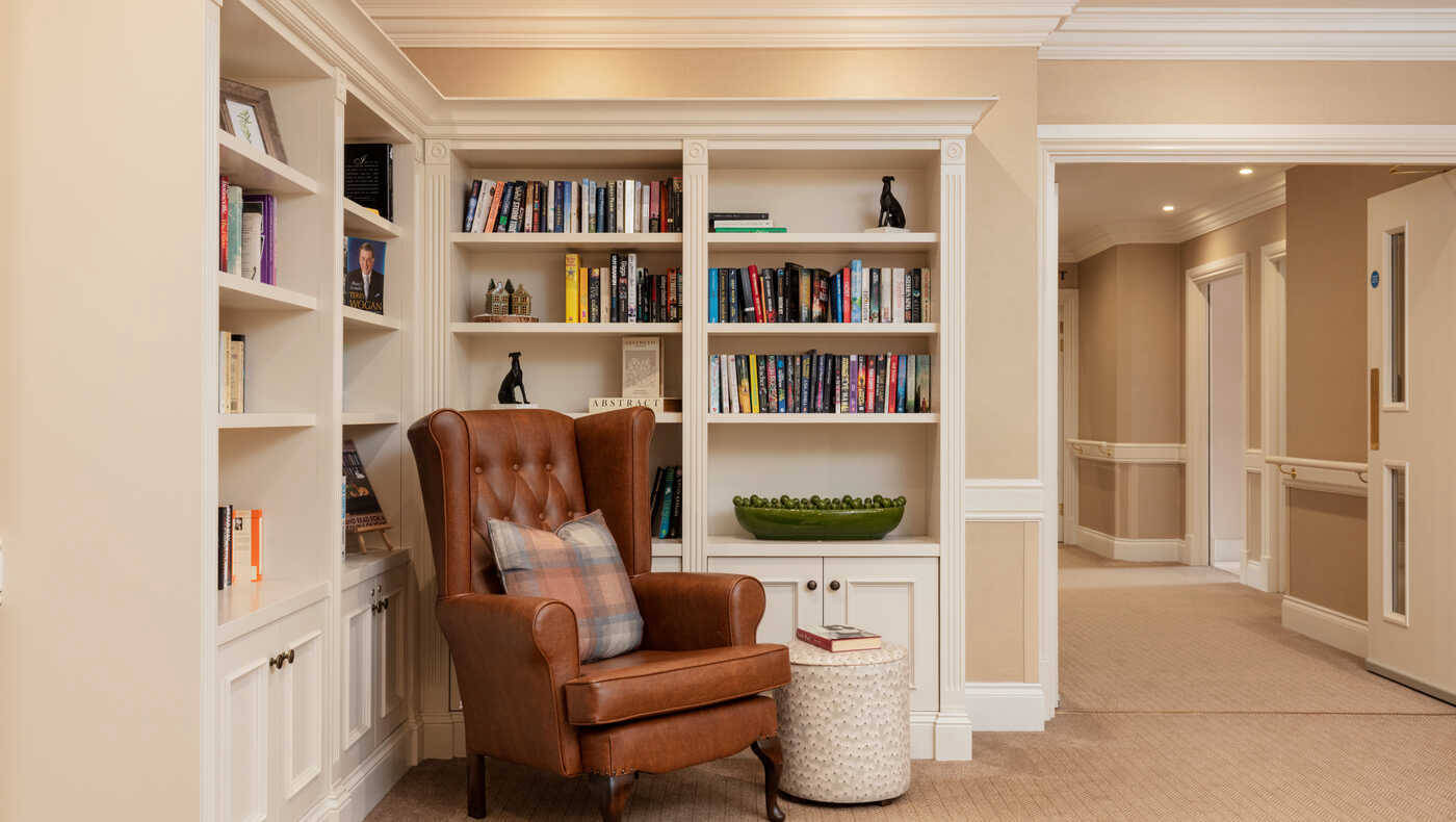 Cozy reading nook with bookshelves in a lounge