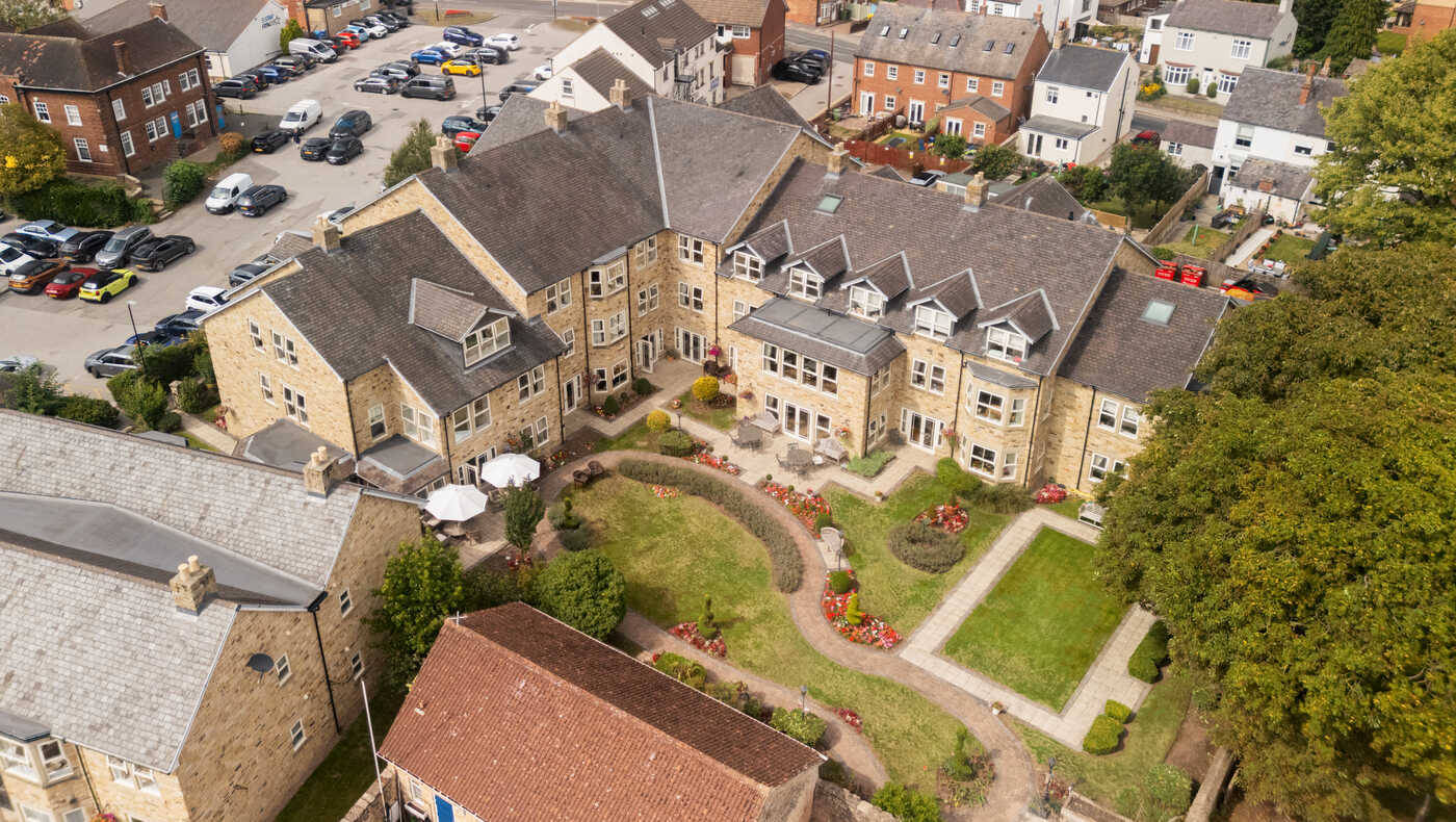 Aerial view of a senior living facility with gardens